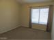 Simple bedroom with carpet flooring and a window at 4302 E Rockledge Rd, Phoenix, AZ 85044