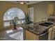 Kitchen boasts granite countertops and an arched window at 4302 E Rockledge Rd, Phoenix, AZ 85044