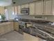 Kitchen features granite countertops and stainless steel appliances at 4302 E Rockledge Rd, Phoenix, AZ 85044