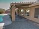 Covered patio adjacent to the pool and house at 4302 E Rockledge Rd, Phoenix, AZ 85044