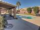 Relaxing backyard oasis with a kidney-shaped pool and patio at 4302 E Rockledge Rd, Phoenix, AZ 85044