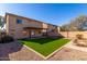 Two-story house with grassy backyard and fire pit at 43864 W Elizabeth Ave, Maricopa, AZ 85138