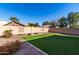 Artificial turf, fire pit, and block wall at 43864 W Elizabeth Ave, Maricopa, AZ 85138