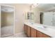 Bathroom with double vanity and adjacent bedroom access at 43864 W Elizabeth Ave, Maricopa, AZ 85138