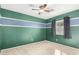 Bedroom with ceiling fan and green walls at 43864 W Elizabeth Ave, Maricopa, AZ 85138