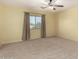 Bright bedroom with ceiling fan and neutral carpeting at 43864 W Elizabeth Ave, Maricopa, AZ 85138