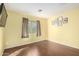 Bright bedroom with wood flooring and neutral walls at 43864 W Elizabeth Ave, Maricopa, AZ 85138