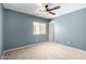 Spacious bedroom with ceiling fan and light walls at 43864 W Elizabeth Ave, Maricopa, AZ 85138