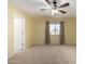 Spacious bedroom featuring ceiling fan and neutral decor at 43864 W Elizabeth Ave, Maricopa, AZ 85138