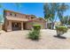 Two-story house with a covered porch, two-car garage, and mature trees at 43864 W Elizabeth Ave, Maricopa, AZ 85138