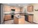 Modern kitchen with stainless steel appliances and an island at 43864 W Elizabeth Ave, Maricopa, AZ 85138