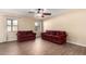 Living room with tile flooring and ceiling fan at 43864 W Elizabeth Ave, Maricopa, AZ 85138