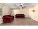 Living room with tile flooring and access to kitchen at 43864 W Elizabeth Ave, Maricopa, AZ 85138