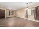 Bright and spacious living room with wood-look tile flooring at 43864 W Elizabeth Ave, Maricopa, AZ 85138