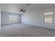 Main bedroom with carpet, large windows, and ceiling fan at 4615 E Bent Tree Dr, Cave Creek, AZ 85331