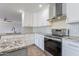 Modern kitchen with white cabinets, granite countertops, and stainless steel appliances at 4615 E Bent Tree Dr, Cave Creek, AZ 85331