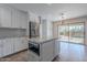 Modern kitchen with island, white cabinets and sliding door to backyard at 4615 E Bent Tree Dr, Cave Creek, AZ 85331