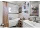 Updated bathroom with a clawfoot tub and modern vanity at 4902 W Cypress St, Phoenix, AZ 85035