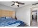 Bedroom with bamboo headboard and access to another room at 4902 W Cypress St, Phoenix, AZ 85035