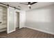 Bedroom with barn door to closet and built-in shelves at 538 N 74Th St, Scottsdale, AZ 85257