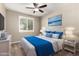 Comfortable bedroom with ceiling fan, window shutters, and ocean art at 5720 S Wildrose --, Mesa, AZ 85212