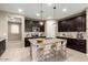 Modern kitchen with dark cabinetry, granite countertops, and an island at 5720 S Wildrose --, Mesa, AZ 85212