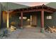 Covered entryway with a wooden door and desert landscaping at 5730 E Cielo N Run, Cave Creek, AZ 85331