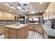 Island kitchen with wood cabinets, granite countertops, and breakfast bar at 5730 E Cielo N Run, Cave Creek, AZ 85331