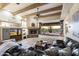 Open living room featuring a stone fireplace, wood beams, and comfortable seating at 5730 E Cielo N Run, Cave Creek, AZ 85331