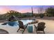 Tranquil pool area with chairs and a waterfall feature at 5730 E Cielo N Run, Cave Creek, AZ 85331