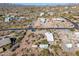 Aerial view of a house and surrounding desert landscape with mountains in the background at 6013 E Lost Dutchman Blvd, Apache Junction, AZ 85119