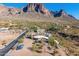 Aerial view of a house and surrounding desert landscape with mountains in the background at 6013 E Lost Dutchman Blvd, Apache Junction, AZ 85119