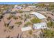 Aerial view showcasing a house, RV, and desert landscaping, with mountains in the distance at 6013 E Lost Dutchman Blvd, Apache Junction, AZ 85119