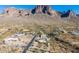 Aerial view of a house and surrounding desert landscape with mountains in the background at 6013 E Lost Dutchman Blvd, Apache Junction, AZ 85119