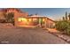 Southwest style home exterior, well-lit at dusk, with mountain backdrop at 6013 E Lost Dutchman Blvd, Apache Junction, AZ 85119