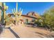 Desert home exterior with unique landscaping and mountain backdrop at 6013 E Lost Dutchman Blvd, Apache Junction, AZ 85119