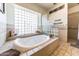 Relaxing bathroom featuring a large bathtub and tile at 6052 N 183Rd Ave, Waddell, AZ 85355