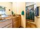 Bathroom with wood vanity and world map shower curtain at 6052 N 183Rd Ave, Waddell, AZ 85355