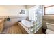 Bathroom with a tiled bathtub and glass block window at 6052 N 183Rd Ave, Waddell, AZ 85355