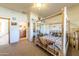 Bedroom with wooden four-poster bed and closet at 6052 N 183Rd Ave, Waddell, AZ 85355