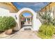 Entrance courtyard with arched walkway and lush landscaping at 6052 N 183Rd Ave, Waddell, AZ 85355