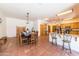 Large dining area with a rustic wooden table and seating at 6052 N 183Rd Ave, Waddell, AZ 85355