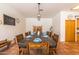 Rustic dining area with wooden table and chairs near kitchen at 6052 N 183Rd Ave, Waddell, AZ 85355