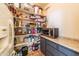 Well-stocked pantry with ample shelving for storage at 6052 N 183Rd Ave, Waddell, AZ 85355