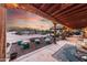 Evening view of covered patio with seating area and fire pit at 6052 N 183Rd Ave, Waddell, AZ 85355