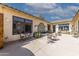 Relaxing patio area with fountain, tables, and chairs at 6052 N 183Rd Ave, Waddell, AZ 85355