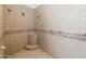 Large walk-in shower with tiled walls and seat at 6052 N 183Rd Ave, Waddell, AZ 85355