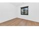 Simple bedroom with hardwood floors and window with mountain view at 6147 E Alta Hacienda Dr, Scottsdale, AZ 85251