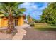 Landscaped backyard with palm trees, a pool, and citrus trees at 6319 N Mockingbird Ln, Paradise Valley, AZ 85253