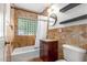 Bathroom with tiled walls, tub, and vanity at 6319 N Mockingbird Ln, Paradise Valley, AZ 85253